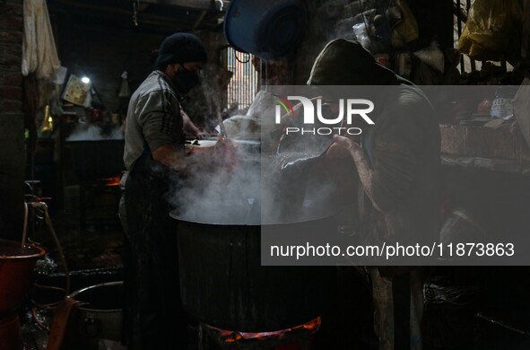 Ashiq Hussain Posh (right) and Waseem Khan (left) dye threads inside a dyeing center in Srinagar, Jammu and Kashmir, on December 16, 2024. K...