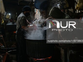 Ashiq Hussain Posh (right) and Waseem Khan (left) dye threads inside a dyeing center in Srinagar, Jammu and Kashmir, on December 16, 2024. K...