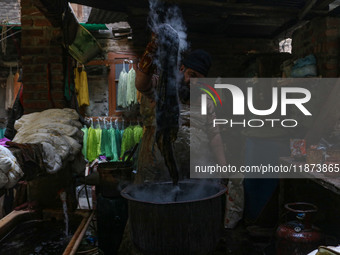 Tariq Ahmad Posh dyes threads inside a dyeing center in Srinagar, Jammu and Kashmir, on December 16, 2024. Kashmiris dye fabric and threads...