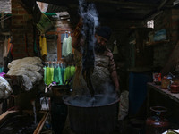 Tariq Ahmad Posh dyes threads inside a dyeing center in Srinagar, Jammu and Kashmir, on December 16, 2024. Kashmiris dye fabric and threads...