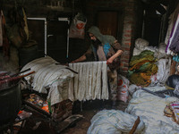 Ashiq Hussain Posh arranges threads inside a dyeing center in Srinagar, Jammu and Kashmir, on December 16, 2024. Kashmiris dye fabric and th...