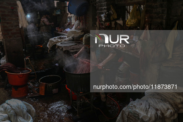 Ashiq Hussain Posh dyes threads inside a dyeing center in Srinagar, Jammu and Kashmir, on December 16, 2024. Kashmiris dye fabric and thread...