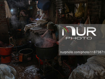 Ashiq Hussain Posh dyes threads inside a dyeing center in Srinagar, Jammu and Kashmir, on December 16, 2024. Kashmiris dye fabric and thread...