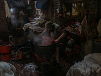 Ashiq Hussain Posh dyes threads inside a dyeing center in Srinagar, Jammu and Kashmir, on December 16, 2024. Kashmiris dye fabric and thread...