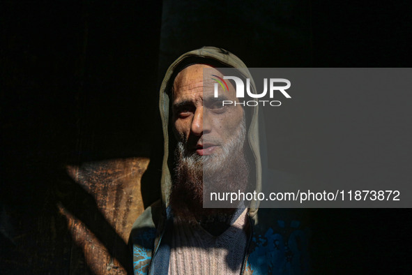 Ashiq Hussain Posh poses for a photograph inside a dyeing center in Srinagar, Jammu and Kashmir, on December 16, 2024. Kashmiris dye fabric...