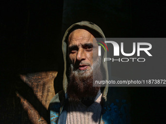 Ashiq Hussain Posh poses for a photograph inside a dyeing center in Srinagar, Jammu and Kashmir, on December 16, 2024. Kashmiris dye fabric...