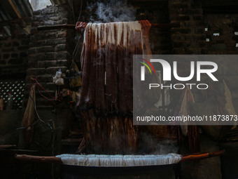 Ashiq Hussain Posh dyes threads inside a dyeing center in Srinagar, Jammu and Kashmir, on December 16, 2024. Kashmiris dye fabric and thread...