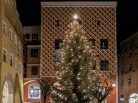 Historic buildings glow with colorful Christmas light projections in Wasserburg am Inn, Bavaria, Germany, on December 15, 2024. The historic...