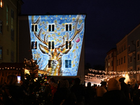 Historic buildings glow with colorful Christmas light projections in Wasserburg am Inn, Bavaria, Germany, on December 15, 2024. The historic...