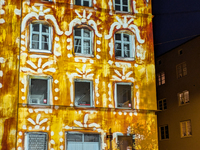 Historic buildings glow with colorful Christmas light projections in Wasserburg am Inn, Bavaria, Germany, on December 15, 2024. The historic...