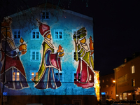 Historic buildings glow with colorful Christmas light projections in Wasserburg am Inn, Bavaria, Germany, on December 15, 2024. The historic...