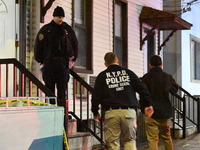 NYPD crime scene investigators investigate where a 32-year-old woman is found dead and a 49-year-old man is wounded in a shooting in College...