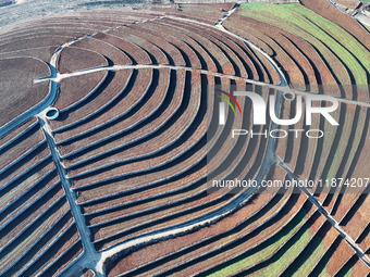 Stacked rice terraces formed by barren mountains are seen in Zaozhuang, China, on December 15, 2024. (