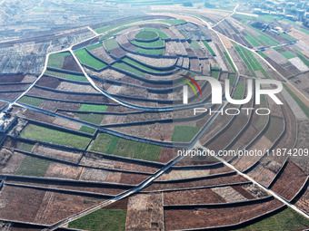 Stacked rice terraces formed by barren mountains are seen in Zaozhuang, China, on December 15, 2024. (