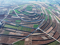 Stacked rice terraces formed by barren mountains are seen in Zaozhuang, China, on December 15, 2024. (