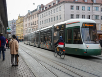 People are near a tram in Augsburg, Bavaria, Germany, on December 14, 2024. The Augsburg tramway is a vital part of the city's public transp...