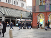 People are near a tram in Augsburg, Bavaria, Germany, on December 14, 2024. The Augsburg tramway is a vital part of the city's public transp...