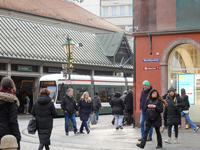 People are near a tram in Augsburg, Bavaria, Germany, on December 14, 2024. The Augsburg tramway is a vital part of the city's public transp...