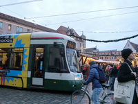 People are near a tram in Augsburg, Bavaria, Germany, on December 14, 2024. The Augsburg tramway is a vital part of the city's public transp...