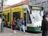 People are near a tram in Augsburg, Bavaria, Germany, on December 14, 2024. The Augsburg tramway is a vital part of the city's public transp...