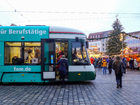 People enter a tram in Augsburg, Bavaria, Germany, on December 14, 2024. The Augsburg tramway is a vital part of the city's public transport...