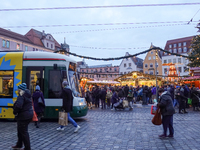 People are near a tram in Augsburg, Bavaria, Germany, on December 14, 2024. The Augsburg tramway is a vital part of the city's public transp...