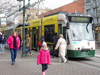 People are near a tram in Augsburg, Bavaria, Germany, on December 14, 2024. The Augsburg tramway is a vital part of the city's public transp...