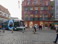 People are near a tram in Augsburg, Bavaria, Germany, on December 14, 2024. The Augsburg tramway is a vital part of the city's public transp...