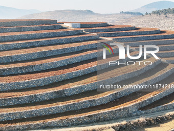 Stacked rice terraces formed by barren mountains are seen in Zaozhuang, China, on December 15, 2024. (