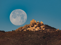 Cold full moon sets behind Rocca Calascio castle and village in Calascio, Italy, on December 16th, 2024. Celts renamed the december full moo...