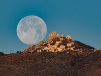 Cold full moon sets behind Rocca Calascio castle and village in Calascio, Italy, on December 16th, 2024. Celts renamed the december full moo...