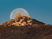 Cold full moon sets behind Rocca Calascio castle and village in Calascio, Italy, on December 16th, 2024. Celts renamed the december full moo...