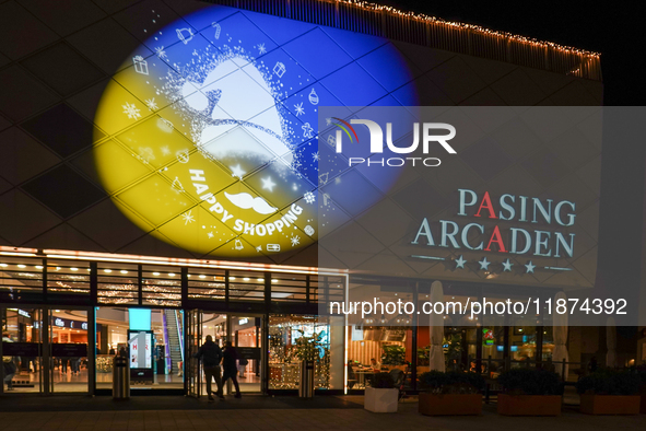 The illuminated entrance of Pasing Arcaden welcomes shoppers with festive decorations in Munich, Bavaria, Germany, on December 14, 2024. Pas...