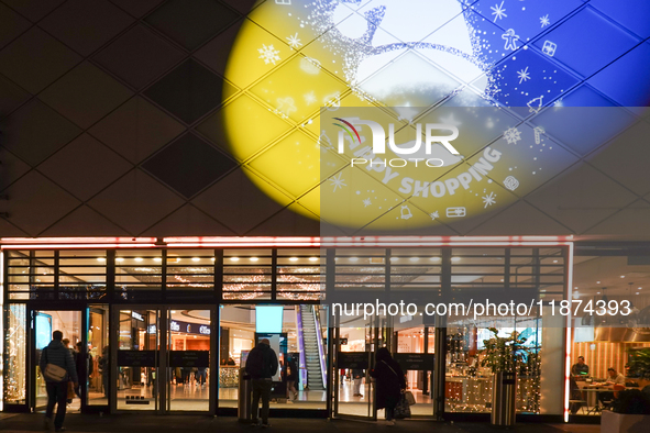 The illuminated entrance of Pasing Arcaden welcomes shoppers with festive decorations in Munich, Bavaria, Germany, on December 14, 2024. Pas...