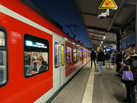 Commuters wait as an S-Bahn suburban train stops at Munich Pasing Station in Munich, Bavaria, Germany, on December 16, 2024. A suburban trai...