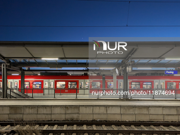 A suburban S-Bahn train waits at Munich Pasing Station in Bavaria, Germany, on December 16, 2024. The station's architecture, with modern st...