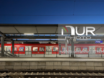 A suburban S-Bahn train waits at Munich Pasing Station in Bavaria, Germany, on December 16, 2024. The station's architecture, with modern st...