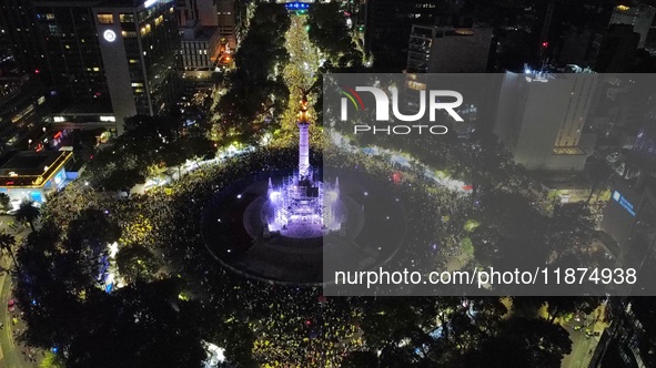 Hundreds of Club America fans attend the Angel de la Independencia Monument to celebrate after Club America wins the first three-time champi...