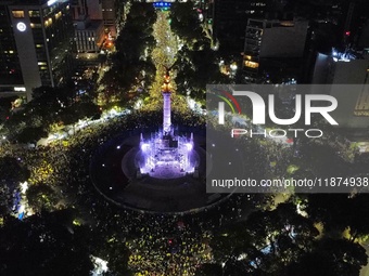 Hundreds of Club America fans attend the Angel de la Independencia Monument to celebrate after Club America wins the first three-time champi...