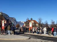 Travelers wait for a bus at Garmisch-Partenkirchen train station in Bavaria, Germany, on December 13, 2024. People gather at the bus stop lo...