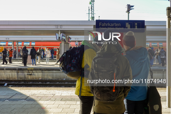 Passengers prepare for their journey at the Bavarian Alps hub. In Garmisch-Partenkirchen station, located in the Bavarian Alps, Germany, on...