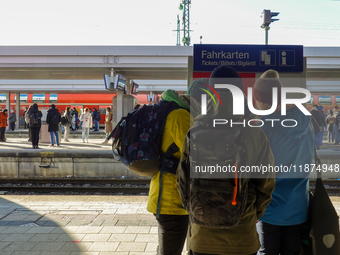 Passengers prepare for their journey at the Bavarian Alps hub. In Garmisch-Partenkirchen station, located in the Bavarian Alps, Germany, on...