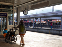 A family prepares to board their train at Garmisch-Partenkirchen station in the Bavarian Alps, Germany, on December 13, 2024. The mother pus...