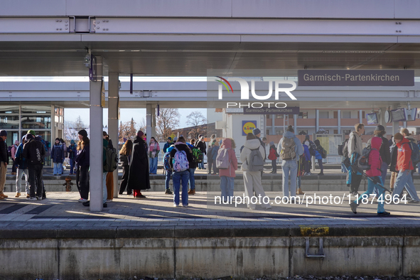 Travelers gather at the Garmisch-Partenkirchen train station in the Bavarian Alps, Germany, on December 13, 2024. The station is bustling wi...