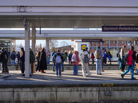 Travelers gather at the Garmisch-Partenkirchen train station in the Bavarian Alps, Germany, on December 13, 2024. The station is bustling wi...