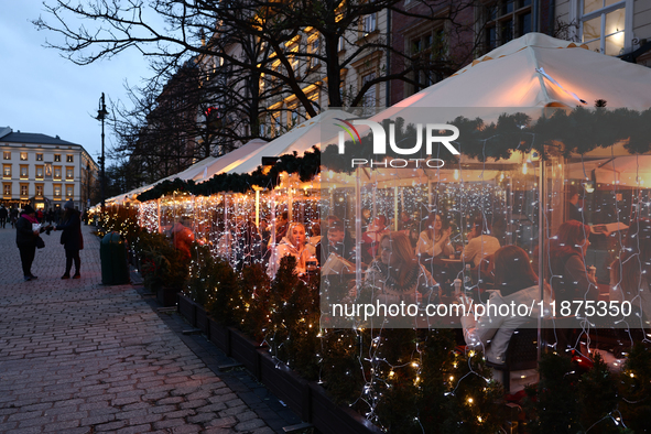 Christmas decorations are seen on a heated restaurant garden at the Main Square in Krakow, Poland on December 16, 2024. 