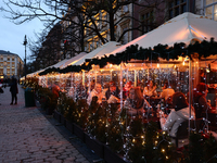 Christmas decorations are seen on a heated restaurant garden at the Main Square in Krakow, Poland on December 16, 2024. (