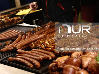 Sausages are seen on a stand at the Christmas fair at Main Square in Krakow, Poland on December 16, 2024. (