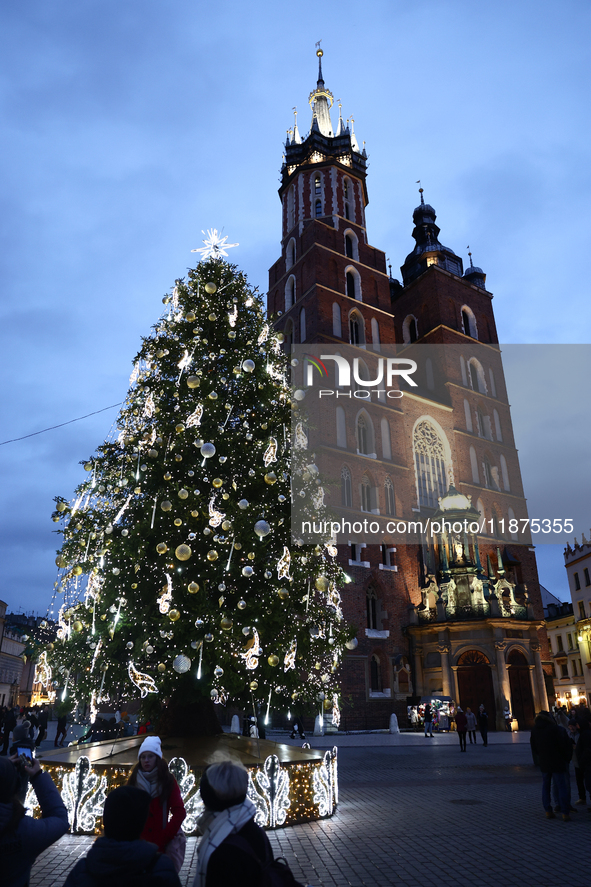 A view of the Christmas tree and St. Mary's Church at Main Square in Krakow, Poland on December 16, 2024. 