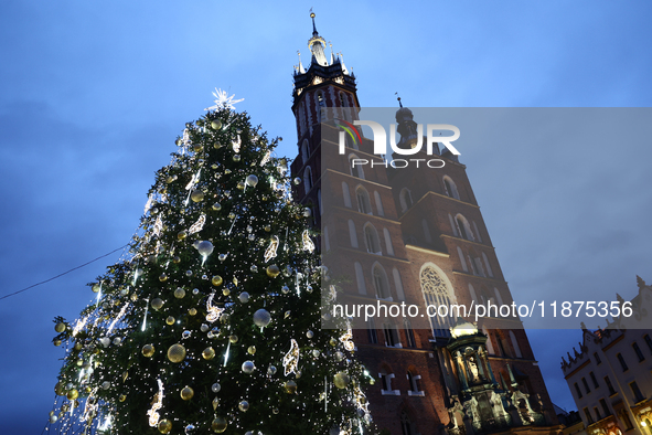 A view of the Christmas tree and St. Mary's Church at Main Square in Krakow, Poland on December 16, 2024. 